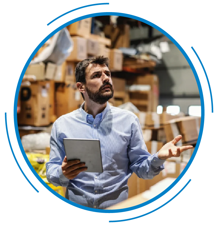 Image of a person holding a tablet in a warehouse