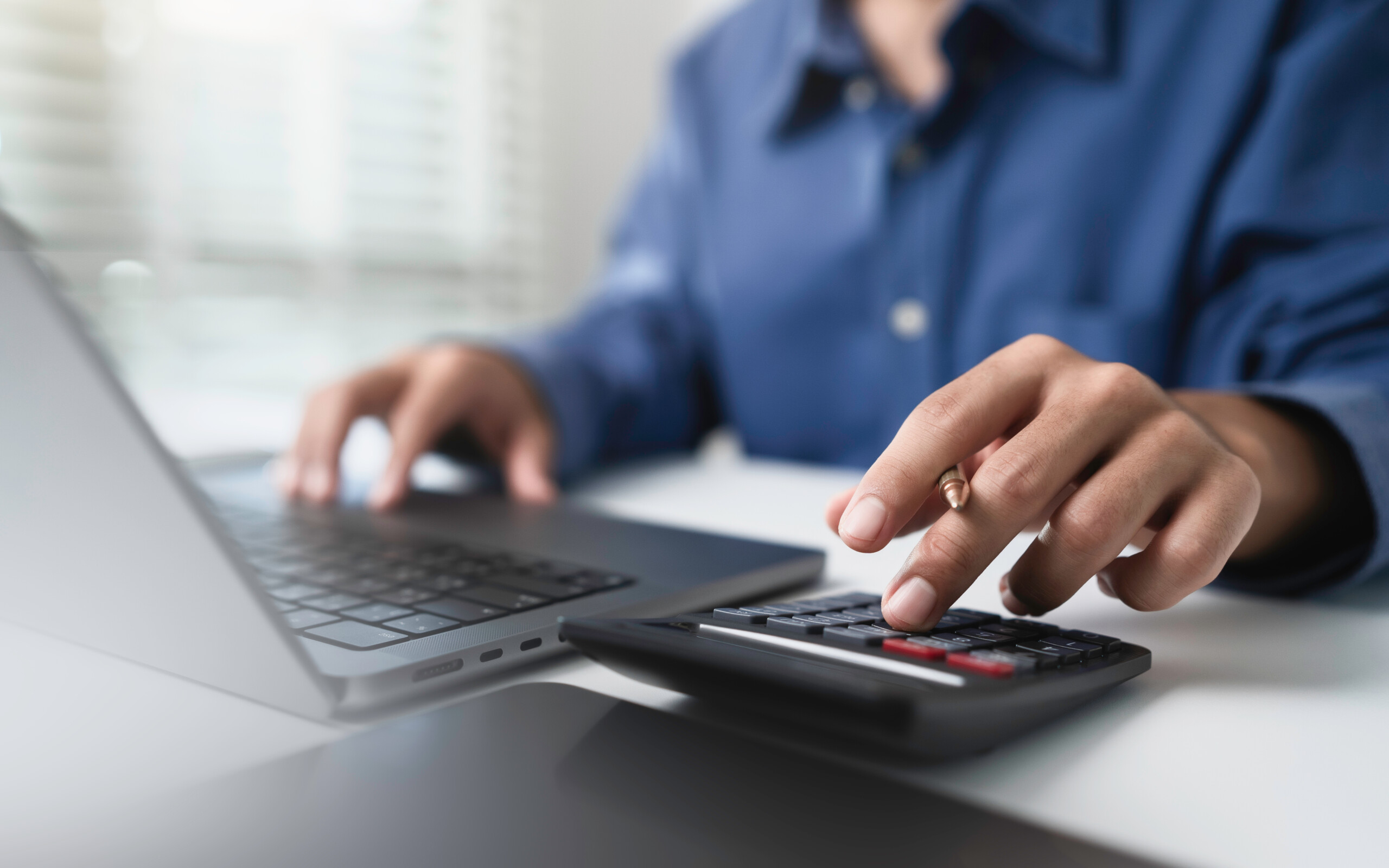 Close up businessman hand using calculator to budget Close up businessman hand using calculator to budget